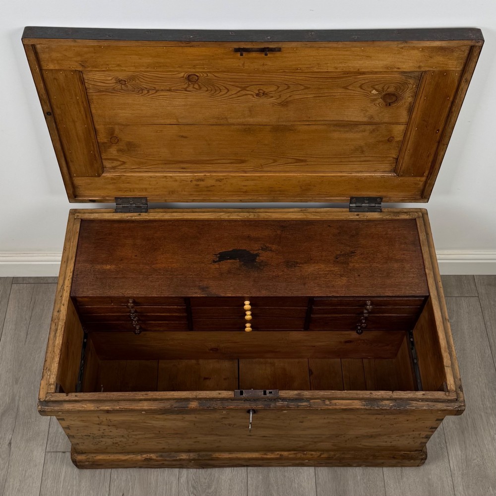 A nineteenth-century pine storage chest featuring visible hand-cut dovetail corner joints and a moulded base. View X
