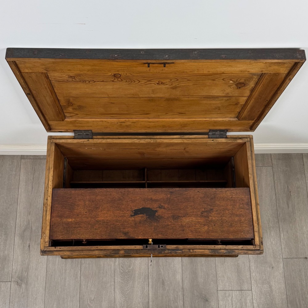 A nineteenth-century pine storage chest featuring visible hand-cut dovetail corner joints and a moulded base. View XII