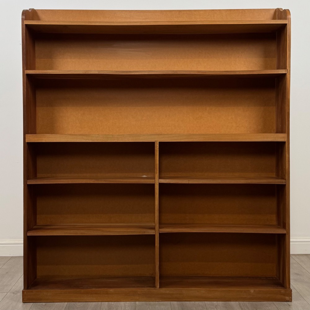 A large twentieth-century open walnut bookcase featuring multiple fixed shelves with a central divider on the lower section.
