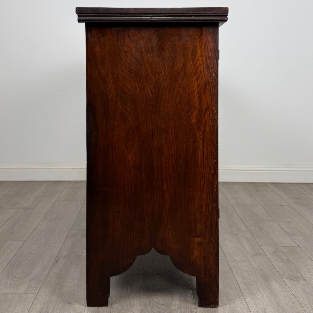 A dark oak Gothic Revival sideboard featuring three central drawers with metal drop ring handles, flanked by two carved tracery panel doors with decorative iron latches. View VIII