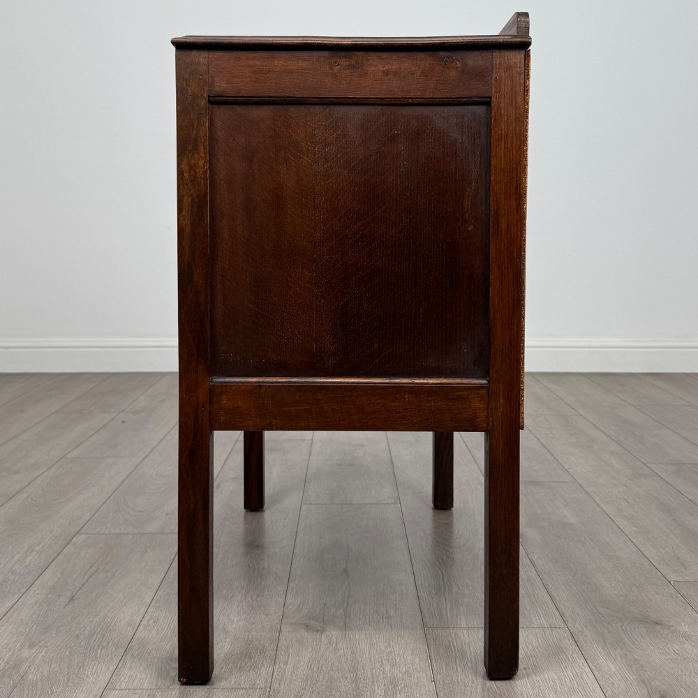 A two-drawer golden oak chest of drawers featuring decorative metal drop handles and straight square legs. View III