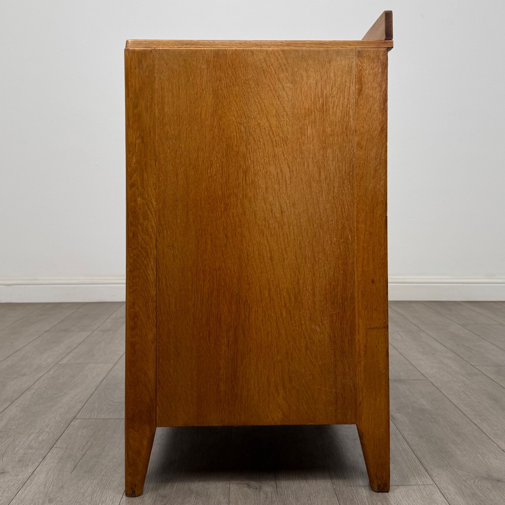 An antique golden oak chest of drawers featuring two short drawers above three long drawers with turned wooden knobs. View III