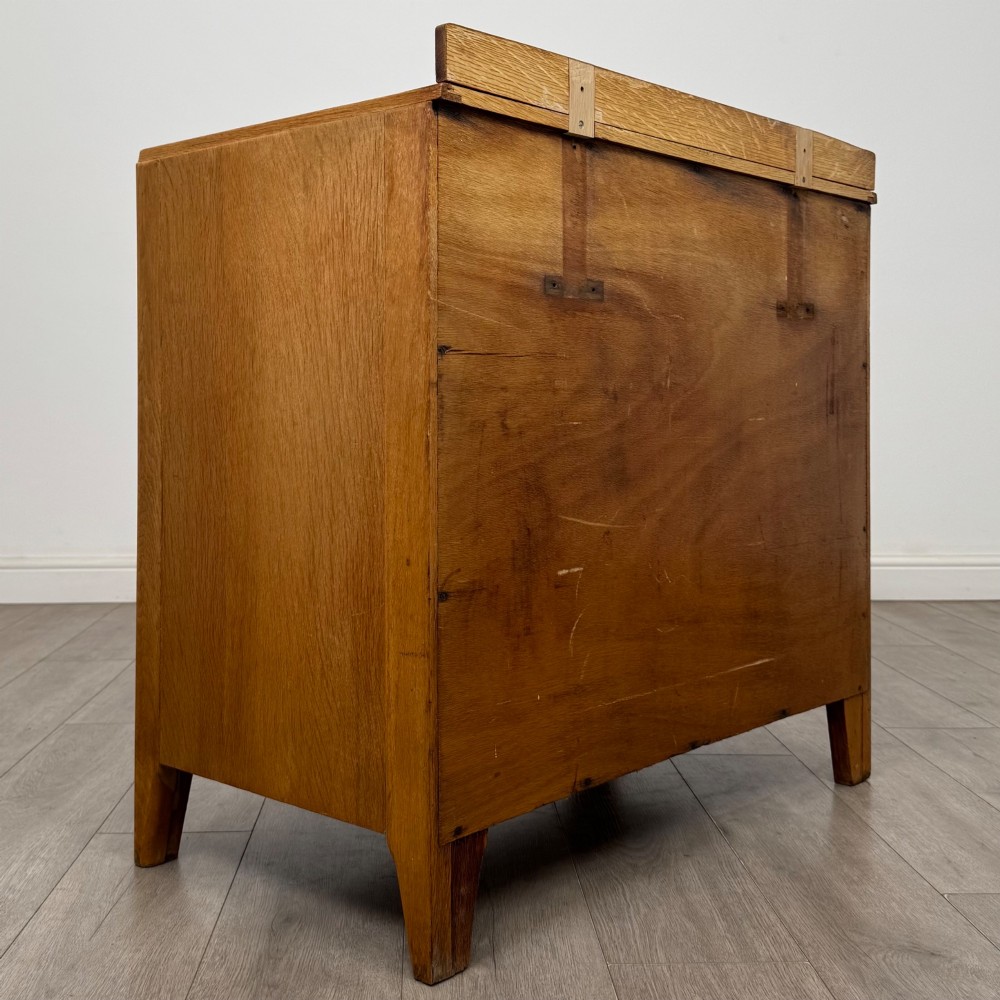 An antique golden oak chest of drawers featuring two short drawers above three long drawers with turned wooden knobs. View IV
