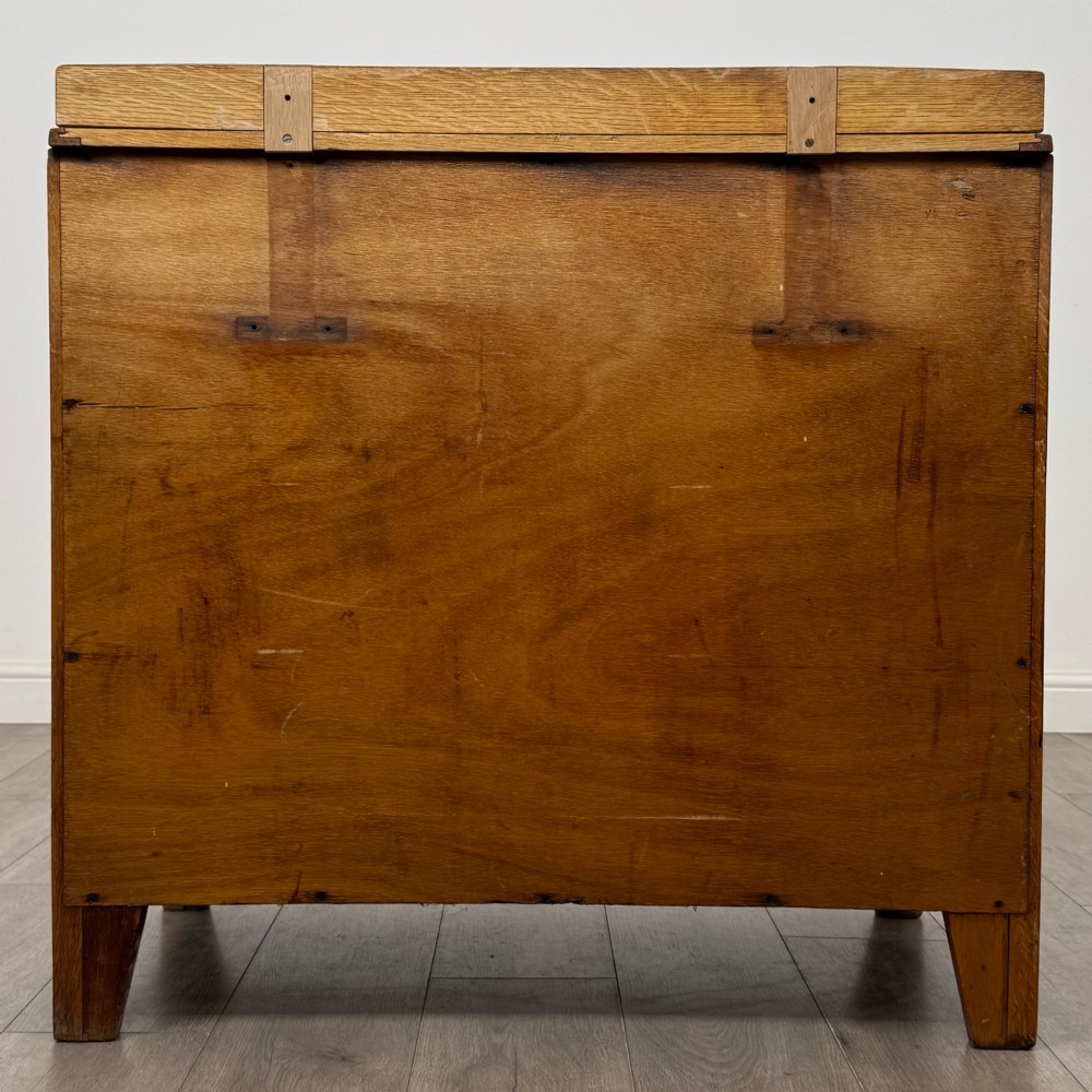 An antique golden oak chest of drawers featuring two short drawers above three long drawers with turned wooden knobs. View V