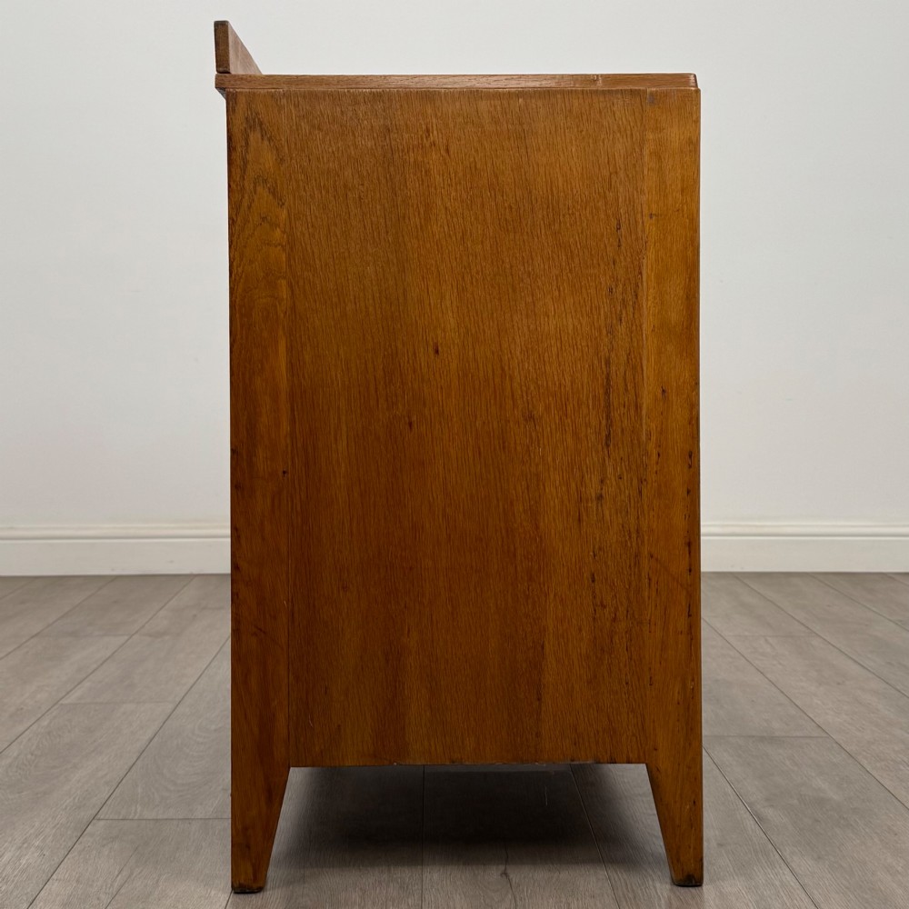 An antique golden oak chest of drawers featuring two short drawers above three long drawers with turned wooden knobs. View VII
