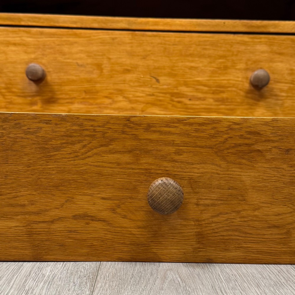 An antique golden oak chest of drawers featuring two short drawers above three long drawers with turned wooden knobs. View XI
