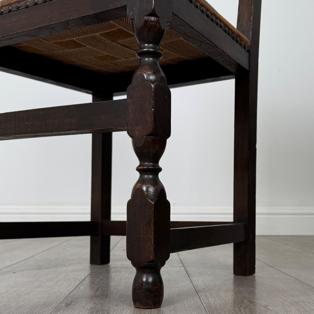 A set of six Edwardian dark oak dining chairs with tan studded leather upholstery, comprising two carver armchairs and four side chairs featuring turned legs. View VIII