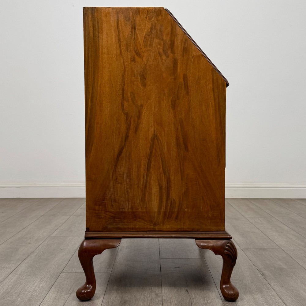An Edwardian burr walnut writing bureau featuring a sloping fall front, three drawers with decorative brass handles, and cabriole legs. View VIII