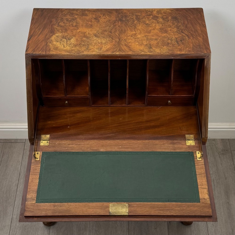 An Edwardian burr walnut writing bureau featuring a sloping fall front, three drawers with decorative brass handles, and cabriole legs. View XI