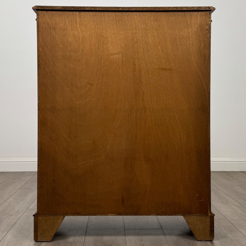 An antique yew wood display cabinet featuring two astragal glazed doors with geometric glazing bars, housing books on internal shelves, and resting on bracket feet. View VII