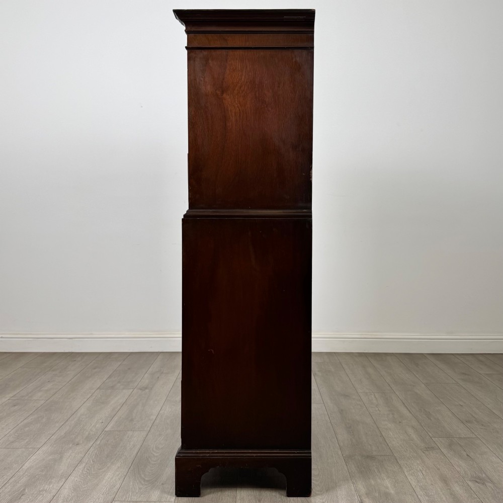 A tall 20th-century mahogany serpentine chest of drawers featuring seven graduated drawers with brass handles and bracket feet. View III
