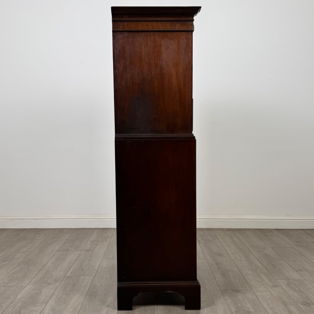 A tall 20th-century mahogany serpentine chest of drawers featuring seven graduated drawers with brass handles and bracket feet. View VII