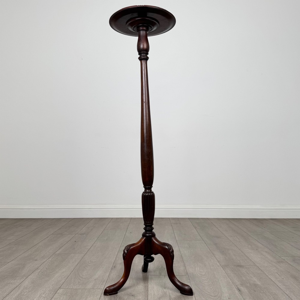 A tall 19th-century Georgian style mahogany torchere stand featuring a circular dished top, turned column, and carved tripod cabriole legs. View II