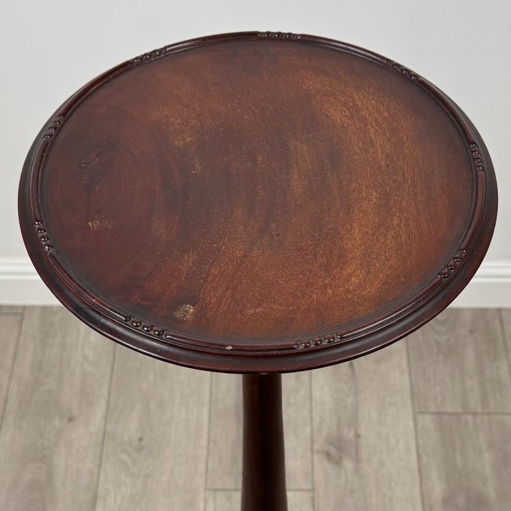 A tall 19th-century Georgian style mahogany torchere stand featuring a circular dished top, turned column, and carved tripod cabriole legs. View IV
