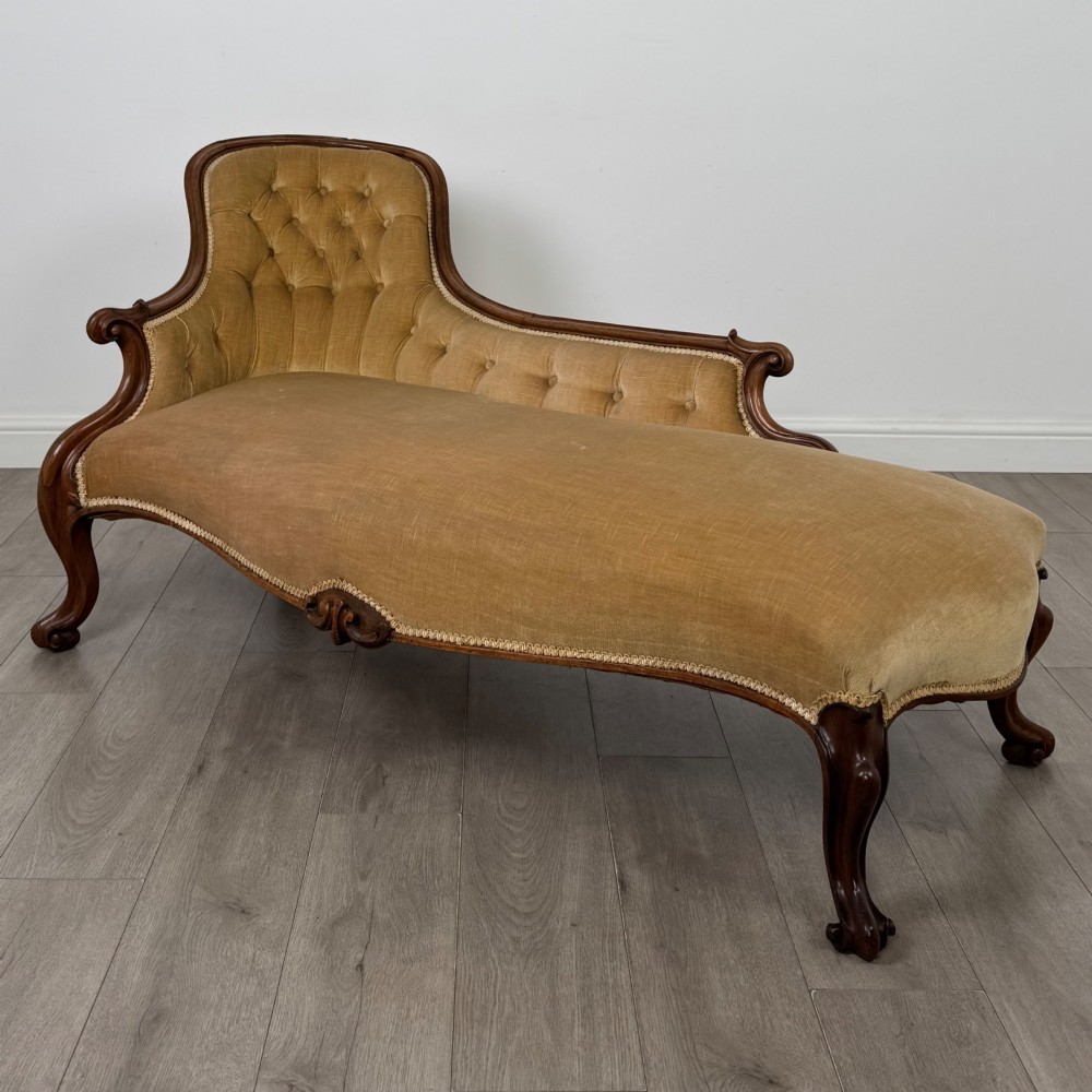 A Victorian mahogany chaise longue featuring ochre velvet button-backed upholstery, carved trim, and cabriole legs. View II