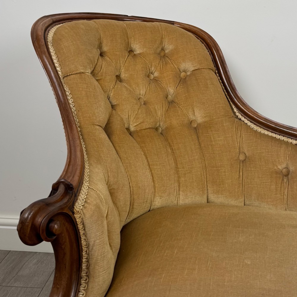 A Victorian mahogany chaise longue featuring ochre velvet button-backed upholstery, carved trim, and cabriole legs. View XI