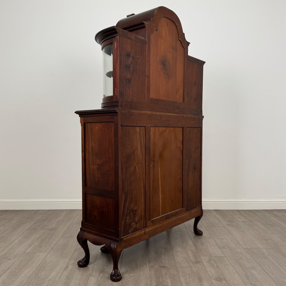 A 19th-century Queen Anne style dark walnut display cabinet featuring curved glass side sections, an arched central glazed door with a carved shell crest, and cabriole legs. View V