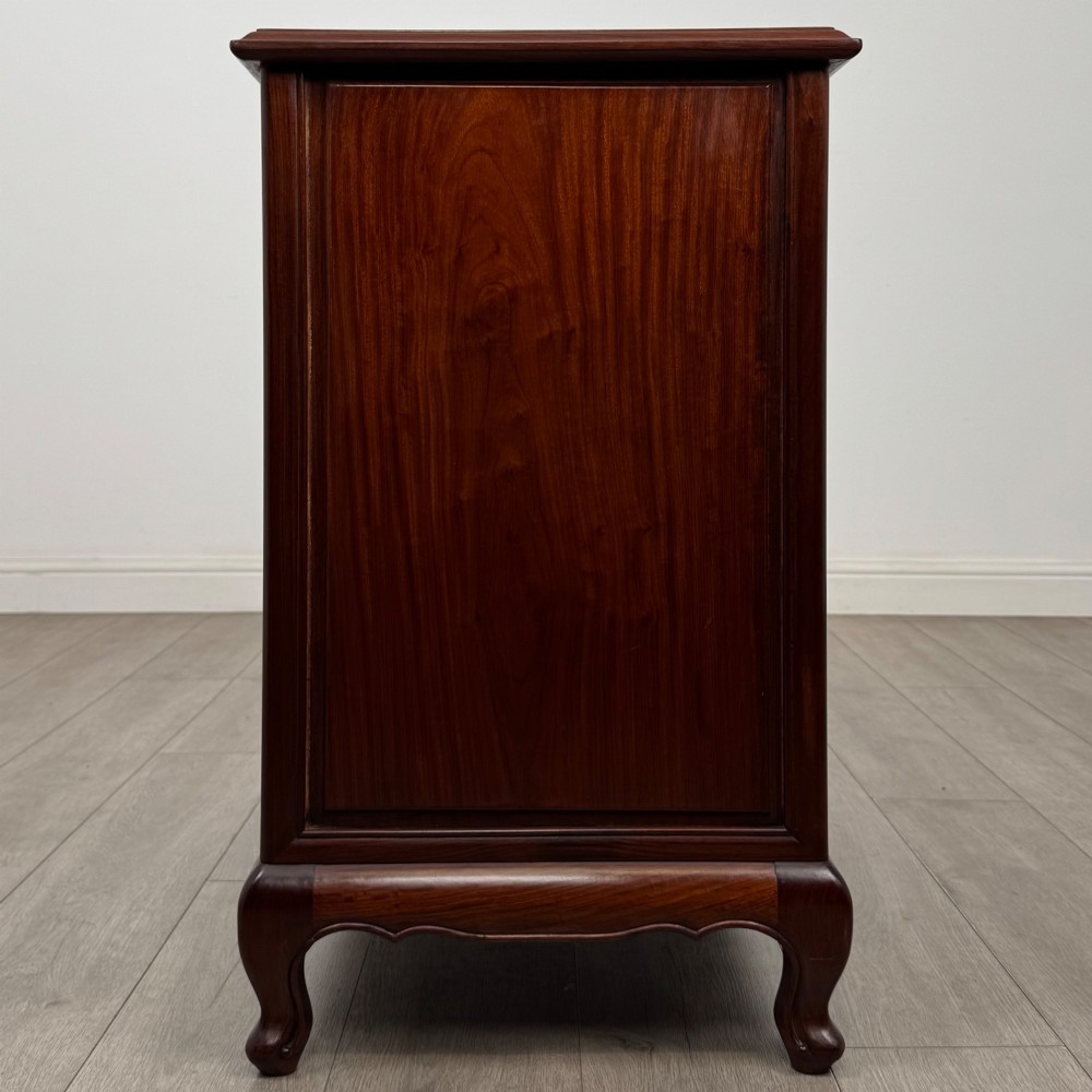 A mahogany chest of drawers featuring a two-over-three drawer arrangement supported on cabriole feet with brass drop handles. View VII
