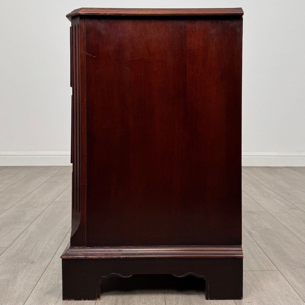 A 20th-century American mahogany chest of drawers featuring two small top drawers, two full-width lower drawers, brass bail handles, fluted quarter-columns, and bracket feet. View III