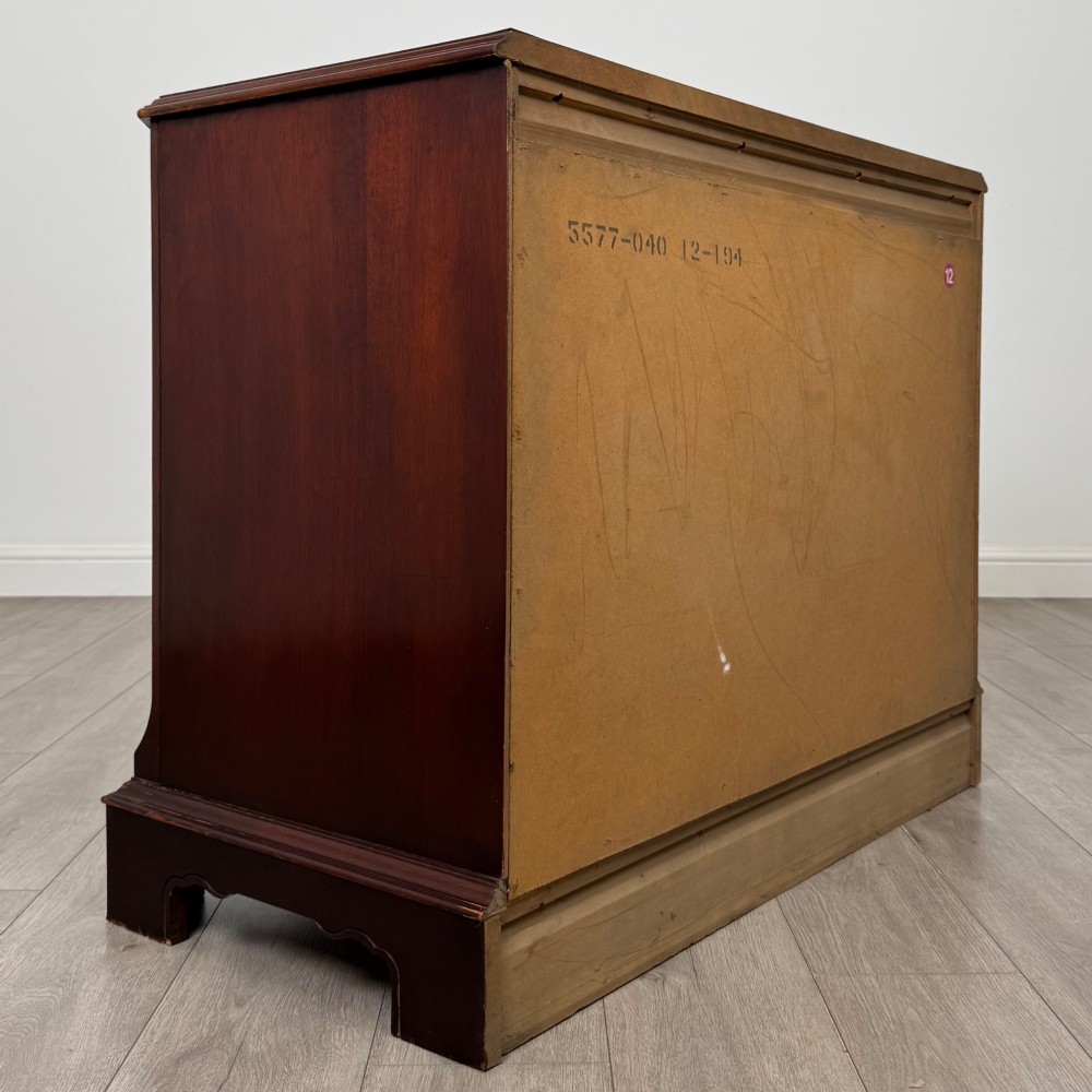 A 20th-century American mahogany chest of drawers featuring two small top drawers, two full-width lower drawers, brass bail handles, fluted quarter-columns, and bracket feet. View IV