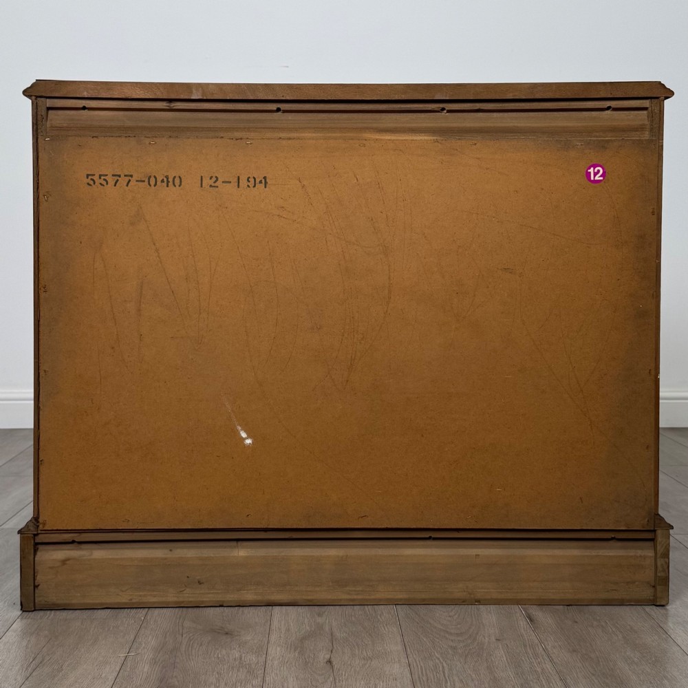 A 20th-century American mahogany chest of drawers featuring two small top drawers, two full-width lower drawers, brass bail handles, fluted quarter-columns, and bracket feet. View V