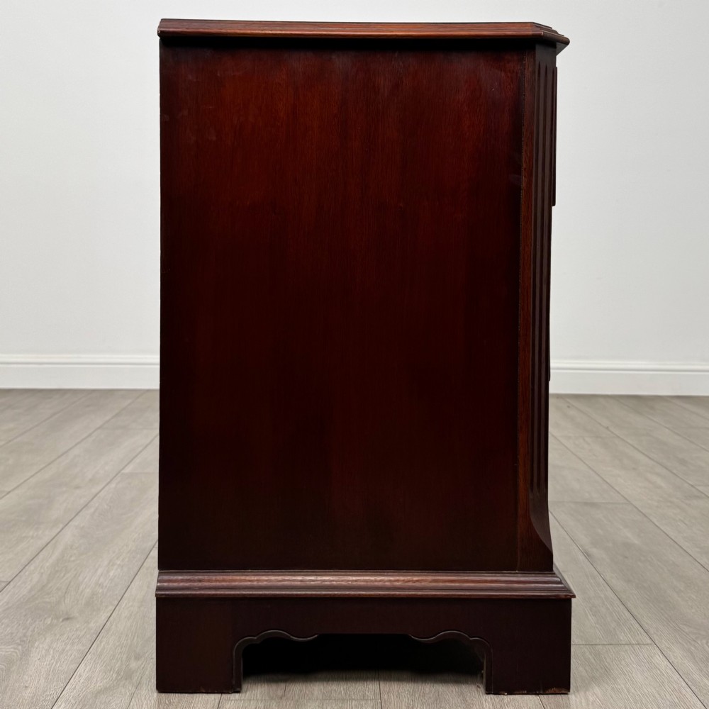 A 20th-century American mahogany chest of drawers featuring two small top drawers, two full-width lower drawers, brass bail handles, fluted quarter-columns, and bracket feet. View VII