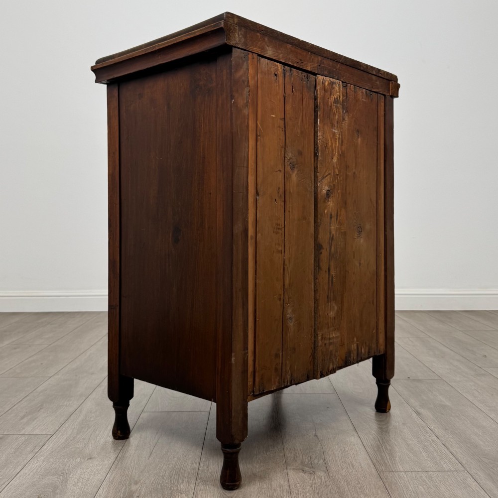 A 19th-century Victorian walnut chest of drawers featuring ornate relief carvings across the drawer fronts and metal drop handles. View IV