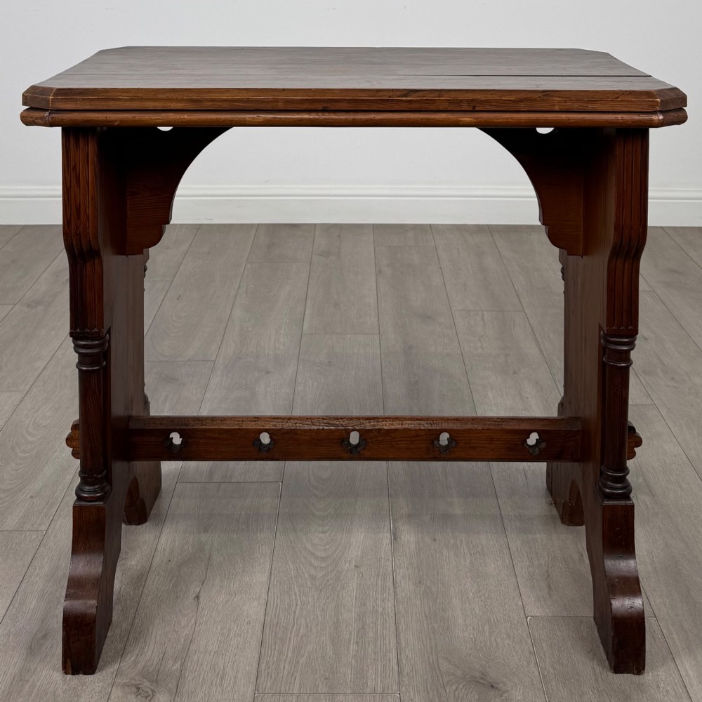 An antique 19th-century pitch pine side table featuring a Gothic Revival trestle base with turned column details and a pegged stretcher. View III