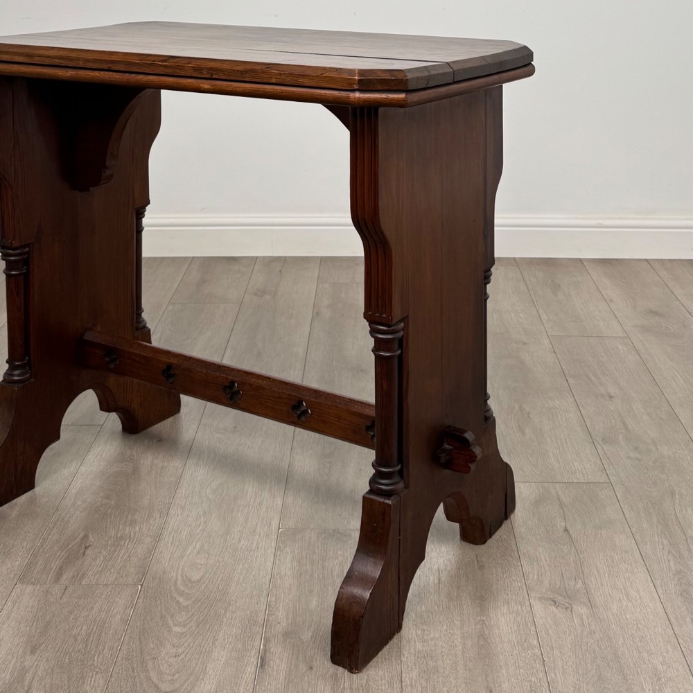 An antique 19th-century pitch pine side table featuring a Gothic Revival trestle base with turned column details and a pegged stretcher. View V