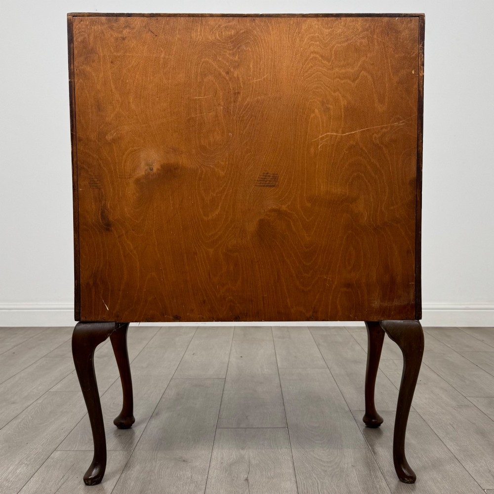 An antique Edwardian burr walnut slant-front bureau featuring two drawers with metal handles, supported by carved cabriole legs. View VI
