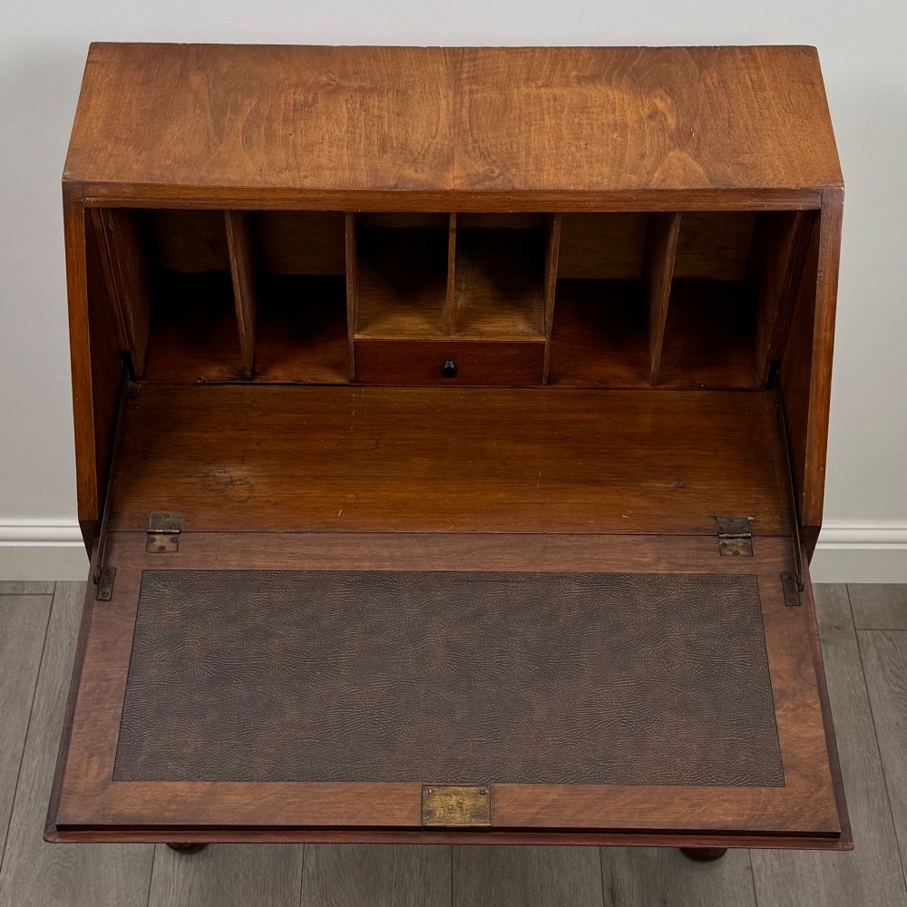 An antique Edwardian burr walnut slant-front bureau featuring two drawers with metal handles, supported by carved cabriole legs. View XI