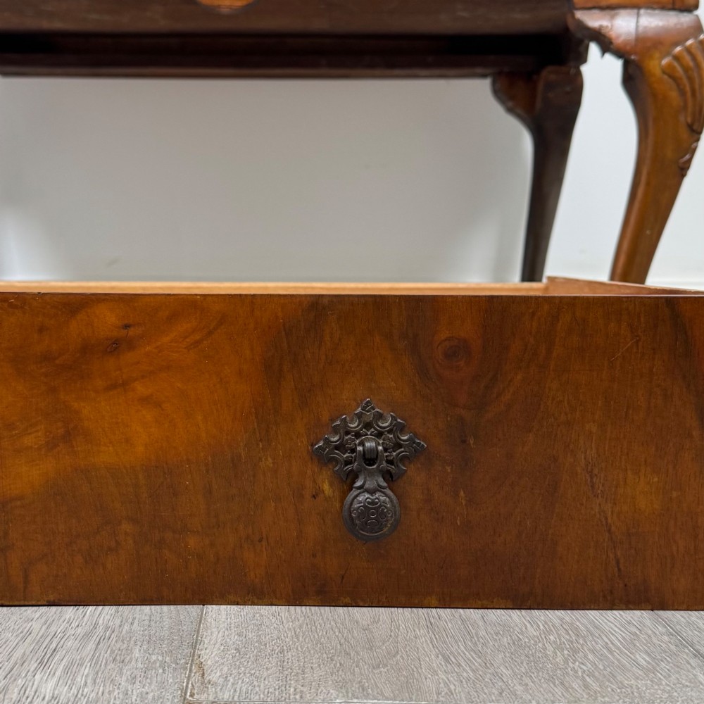 An antique Edwardian burr walnut slant-front bureau featuring two drawers with metal handles, supported by carved cabriole legs. View XIII
