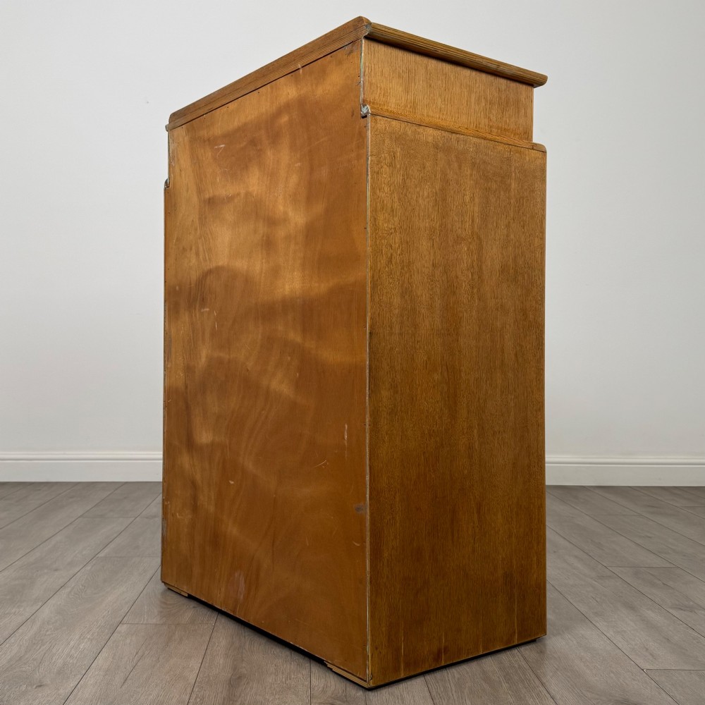 A twentieth-century oak chest featuring four large horizontal drawers below two smaller upper drawers with turned wooden handles and a central carved fluted detail. View VI