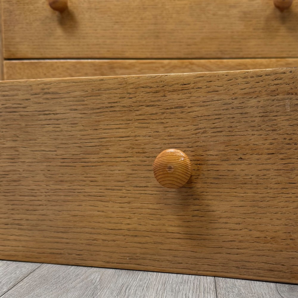 A twentieth-century oak chest featuring four large horizontal drawers below two smaller upper drawers with turned wooden handles and a central carved fluted detail. View XI