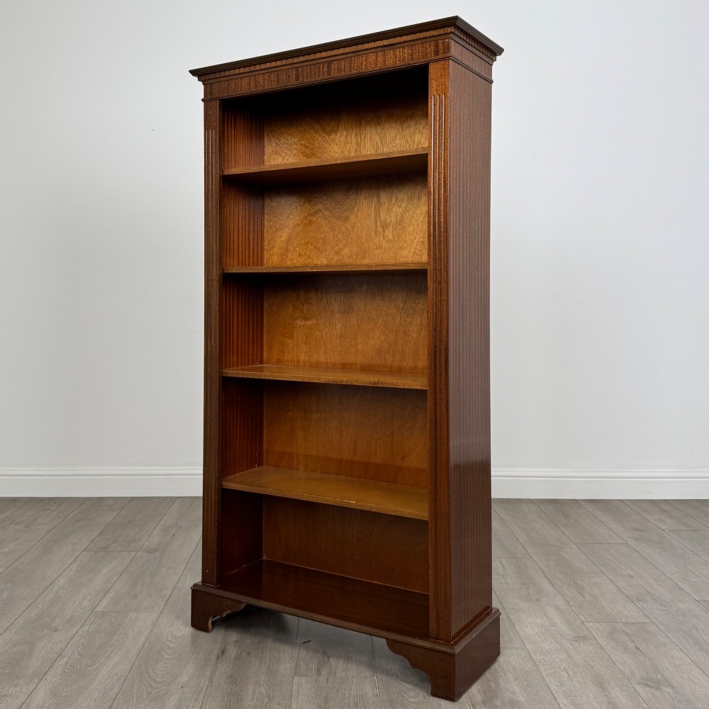 A tall early 20th-century mahogany open bookcase featuring fluted side pilasters, a crossbanded cornice, five shelves, and bracket feet. View III