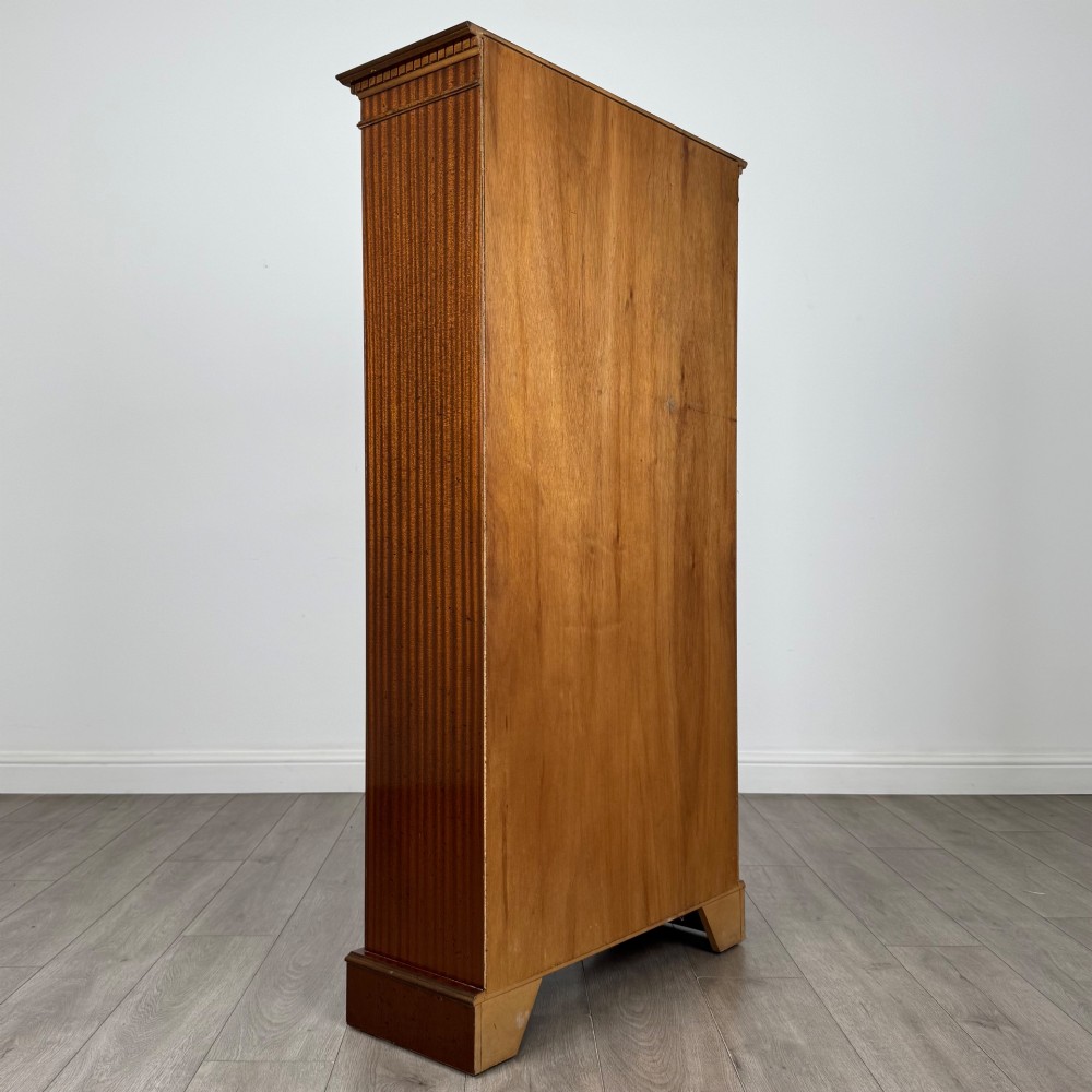 A tall early 20th-century mahogany open bookcase featuring fluted side pilasters, a crossbanded cornice, five shelves, and bracket feet. View V