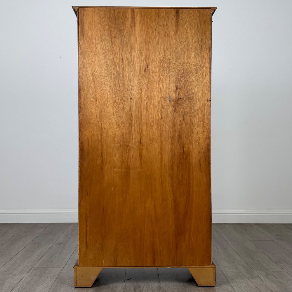 A tall early 20th-century mahogany open bookcase featuring fluted side pilasters, a crossbanded cornice, five shelves, and bracket feet. View VI