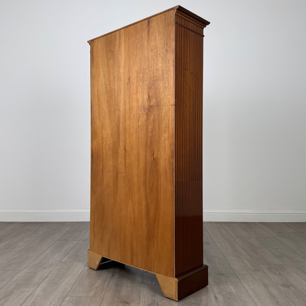 A tall early 20th-century mahogany open bookcase featuring fluted side pilasters, a crossbanded cornice, five shelves, and bracket feet. View VII