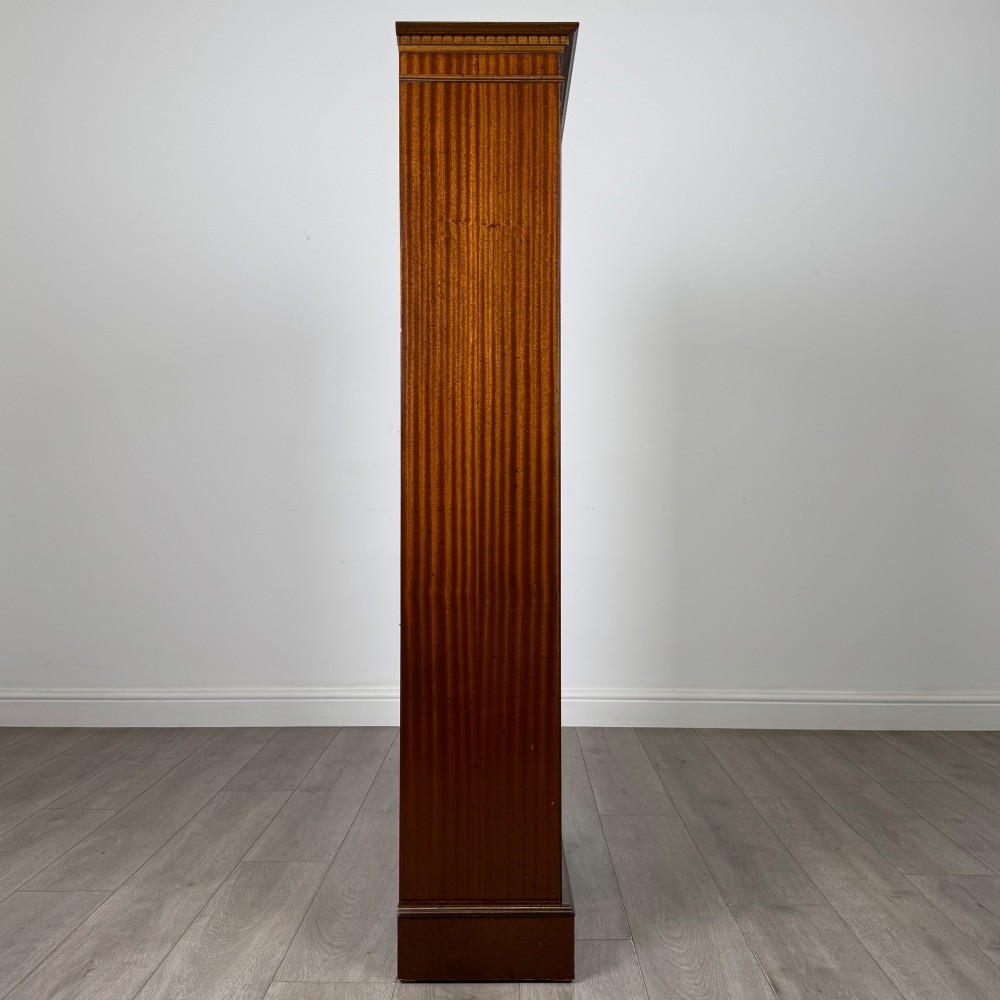 A tall early 20th-century mahogany open bookcase featuring fluted side pilasters, a crossbanded cornice, five shelves, and bracket feet. View VIII