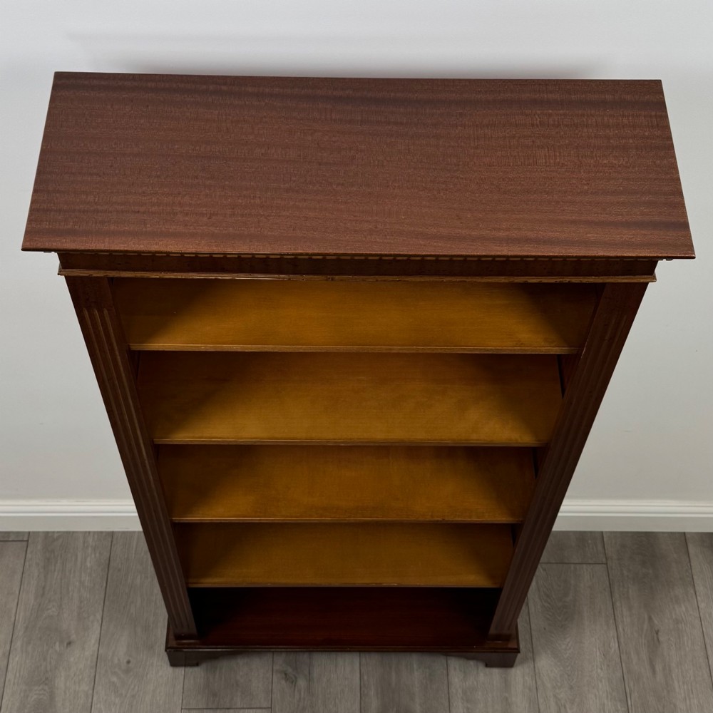 A tall early 20th-century mahogany open bookcase featuring fluted side pilasters, a crossbanded cornice, five shelves, and bracket feet. View X