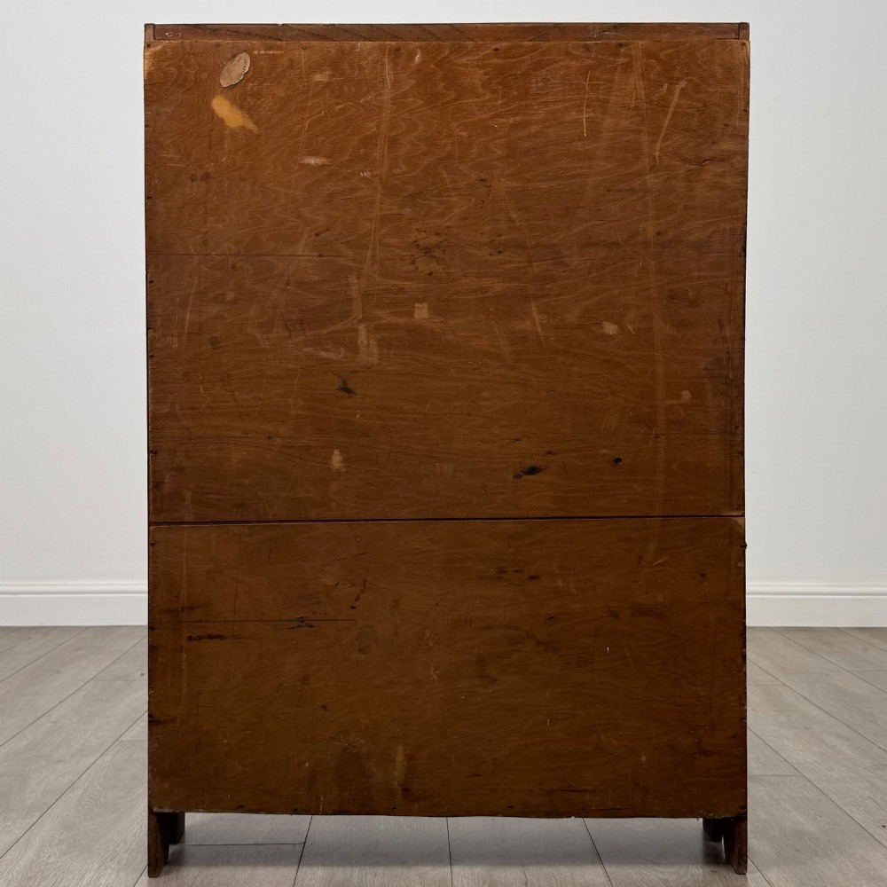 An Edwardian dark oak open bookcase featuring four fixed shelves and shaped side panels. View VI