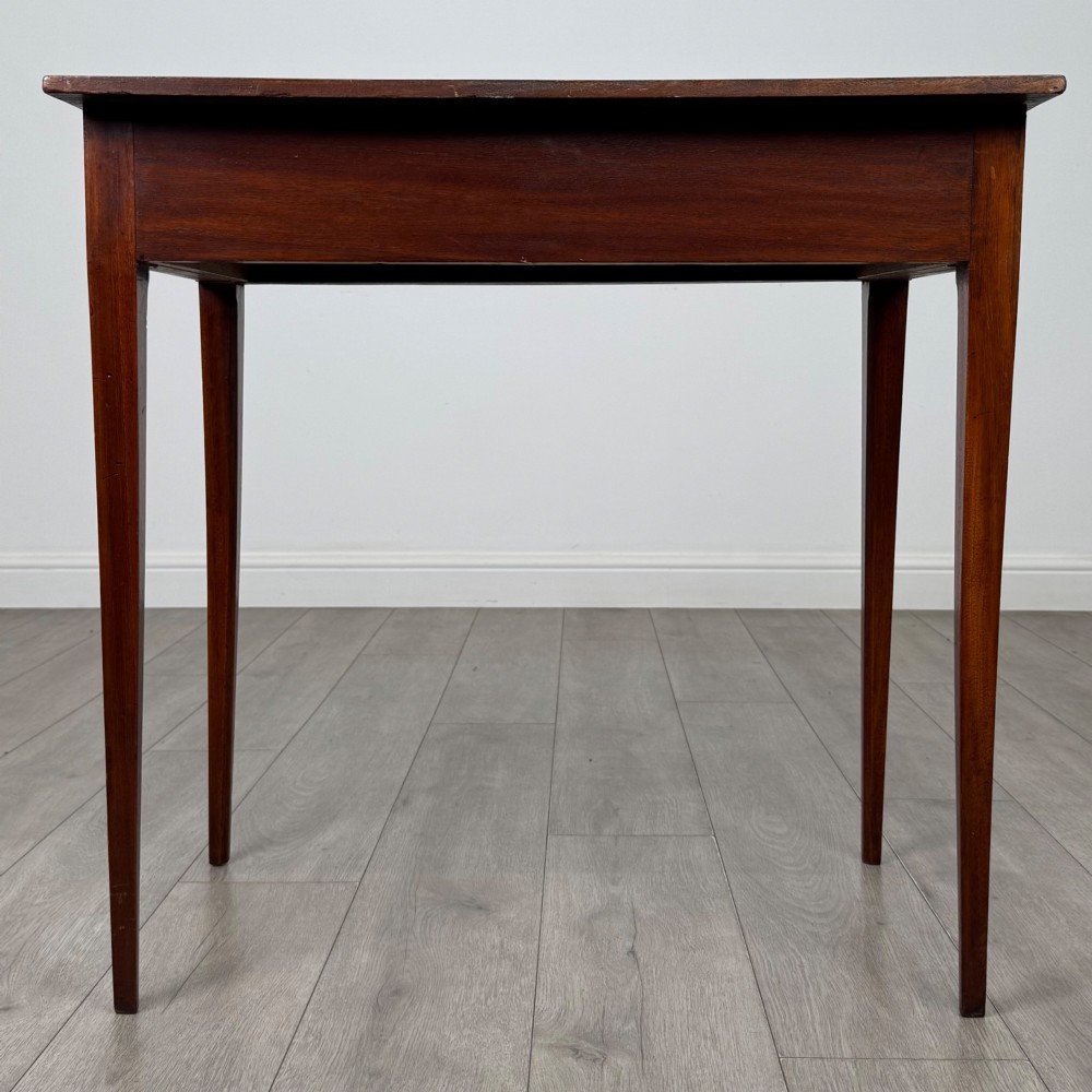 An 18th-century Georgian mahogany writing table featuring a single full-width drawer with two circular brass handles and tapered square legs. View V