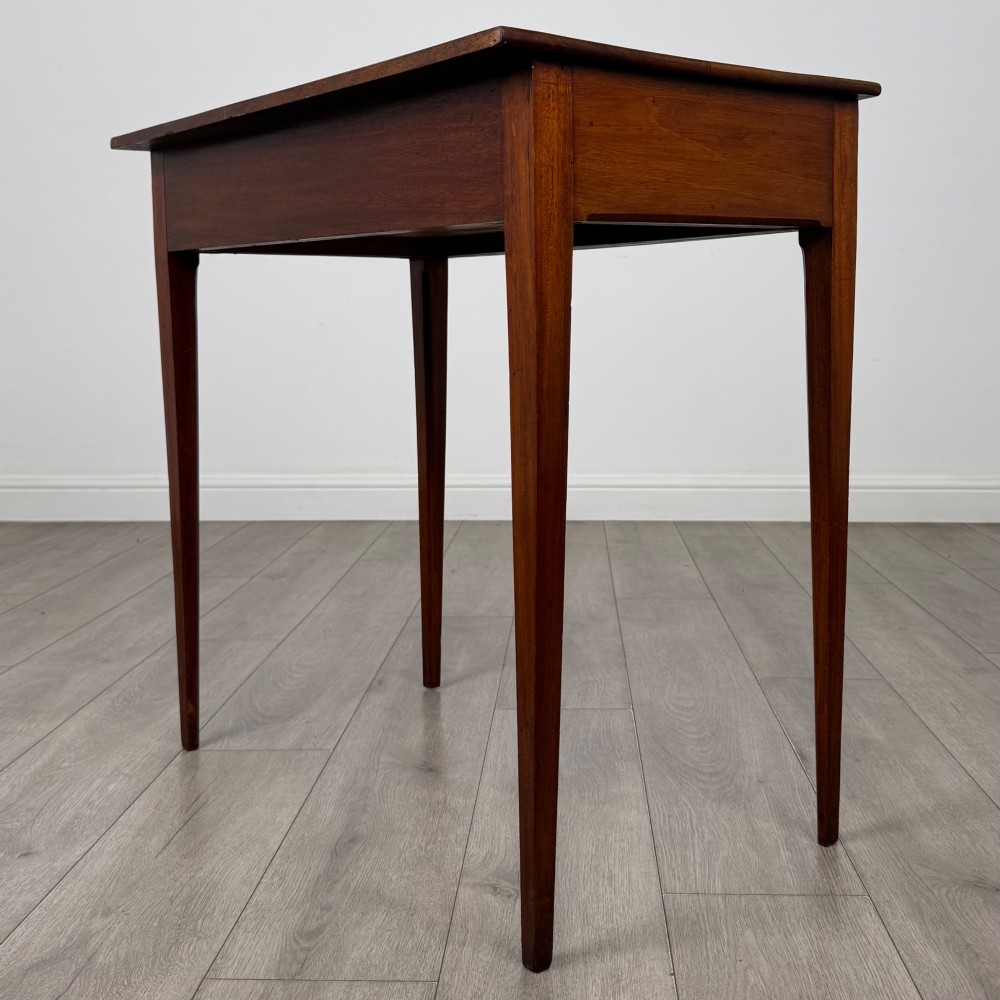 An 18th-century Georgian mahogany writing table featuring a single full-width drawer with two circular brass handles and tapered square legs. View VI