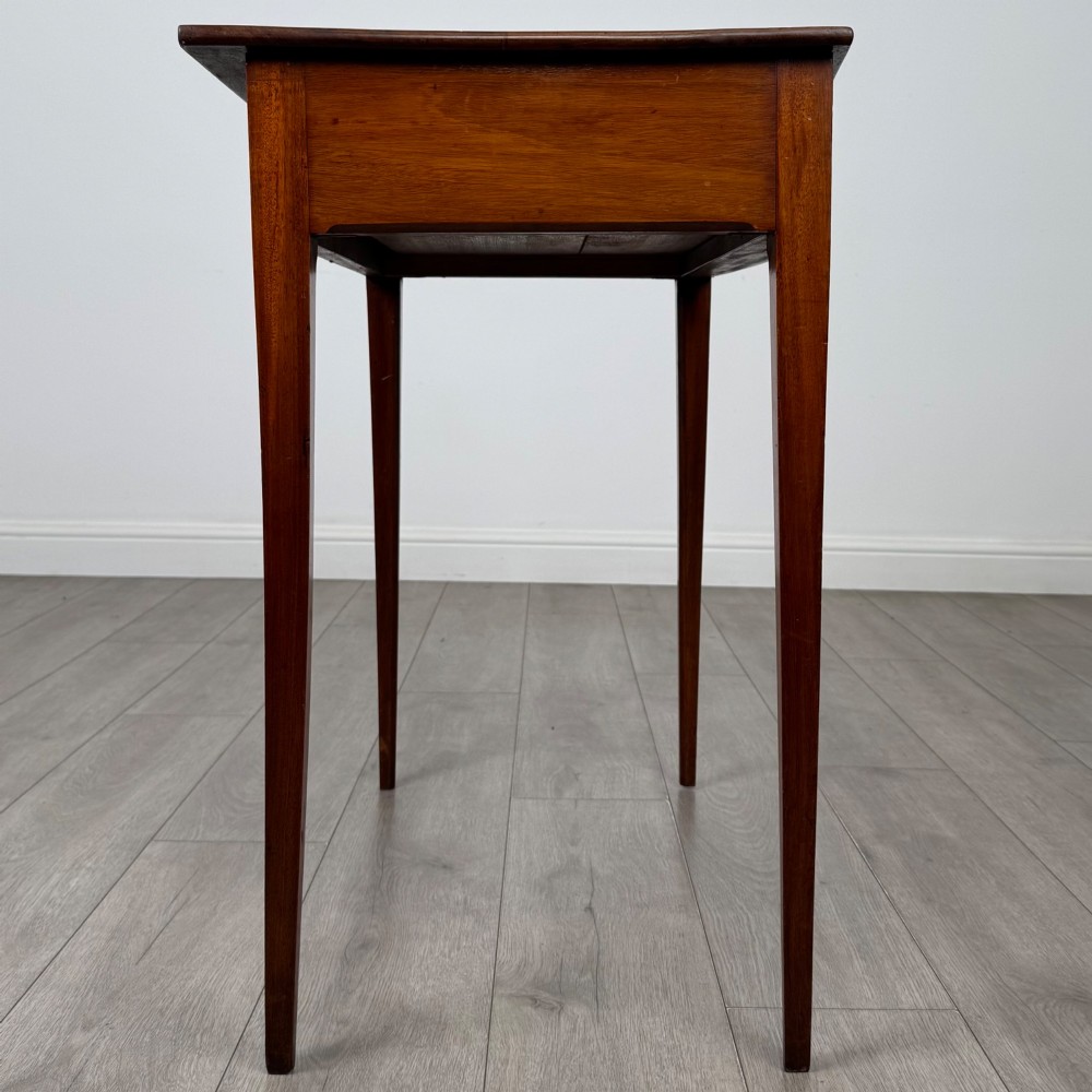 An 18th-century Georgian mahogany writing table featuring a single full-width drawer with two circular brass handles and tapered square legs. View VII