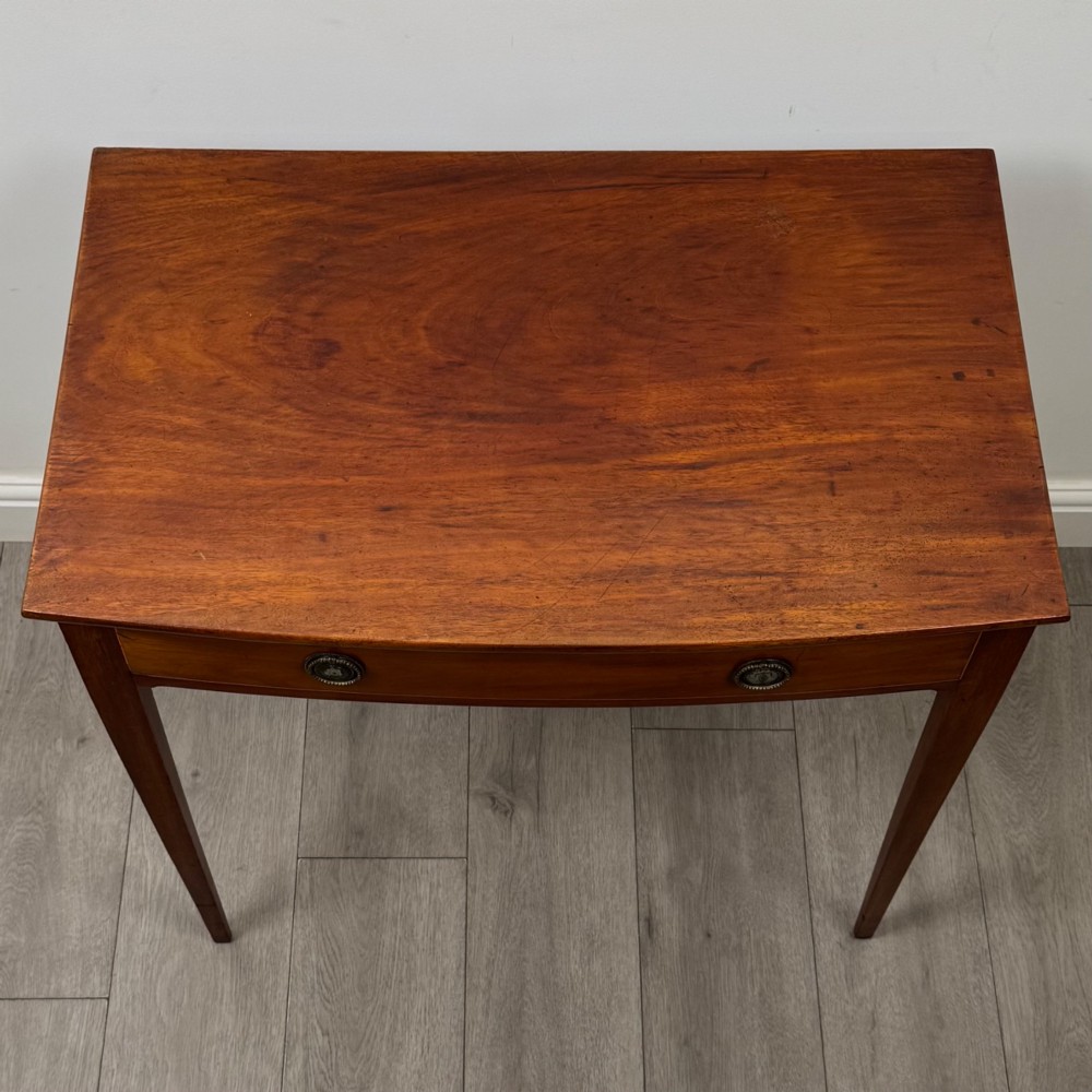 An 18th-century Georgian mahogany writing table featuring a single full-width drawer with two circular brass handles and tapered square legs. View IX