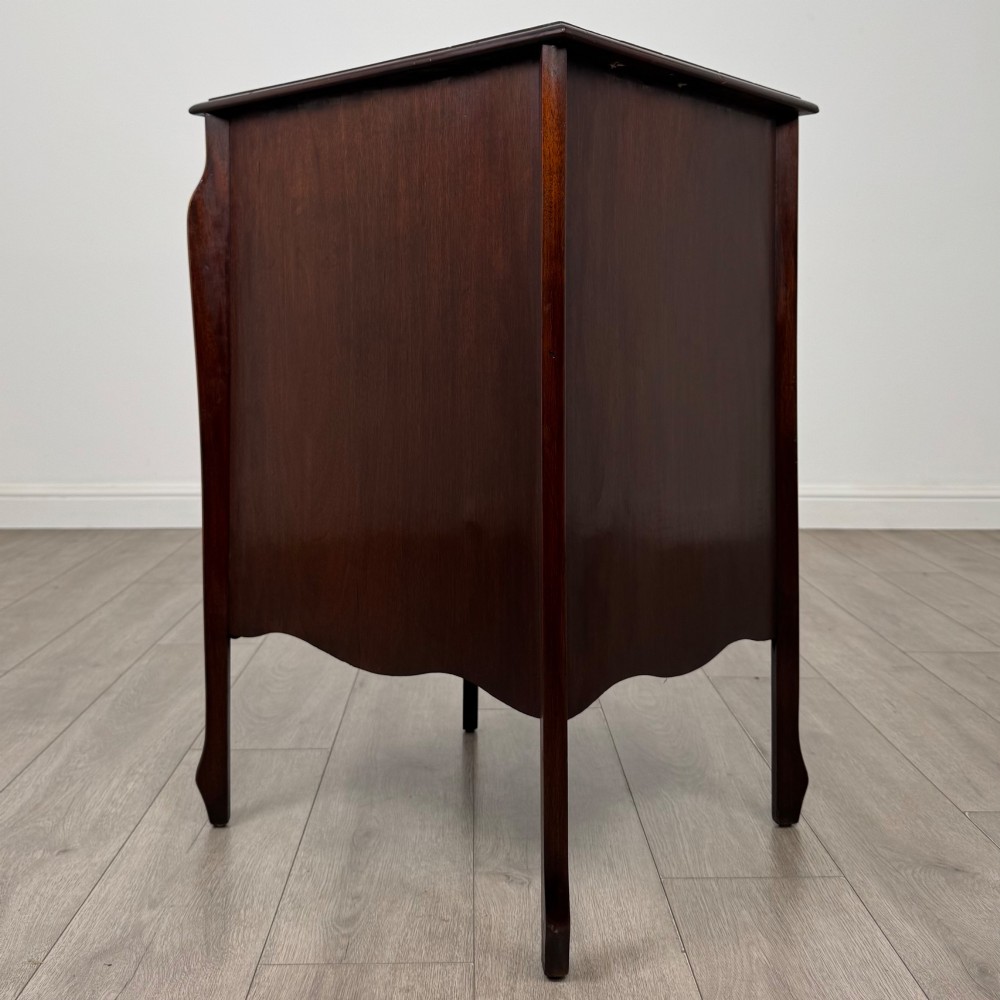 An antique Edwardian mahogany cabinet with double panelled doors, brass knobs, and elevated curved legs. View V