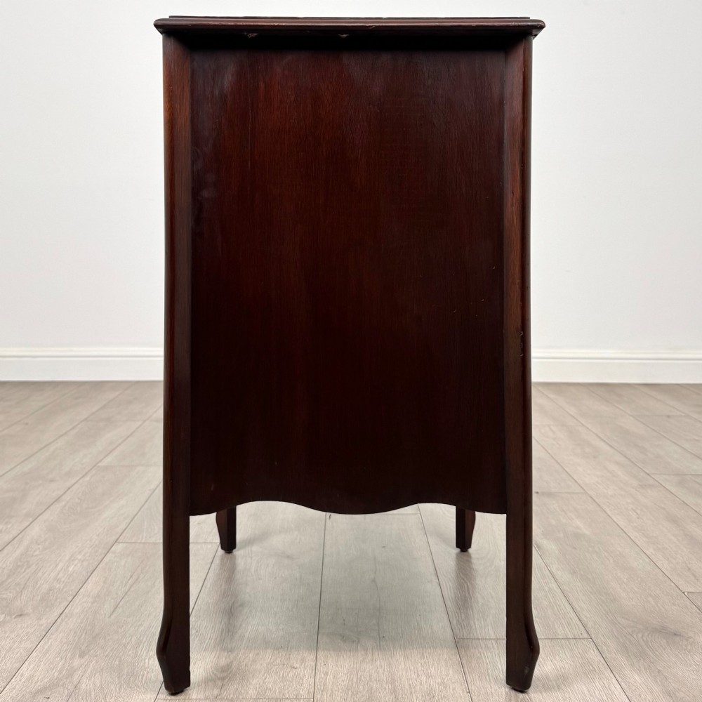 An antique Edwardian mahogany cabinet with double panelled doors, brass knobs, and elevated curved legs. View VI