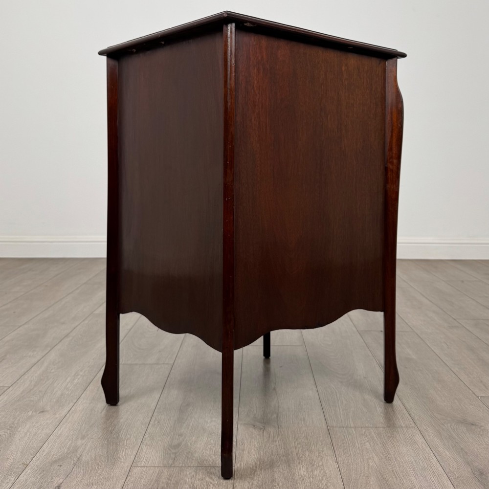 An antique Edwardian mahogany cabinet with double panelled doors, brass knobs, and elevated curved legs. View VII