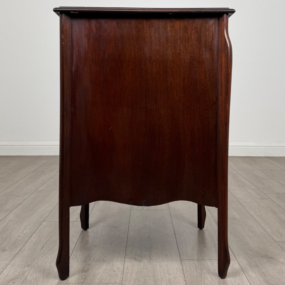 An antique Edwardian mahogany cabinet with double panelled doors, brass knobs, and elevated curved legs. View VIII