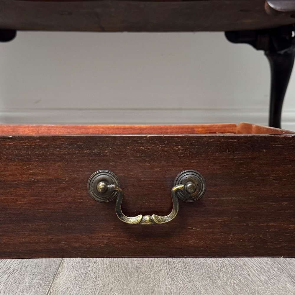 A dark mahogany chest of drawers featuring three long drawers with brass handles, raised on carved cabriole legs ending in ball and claw feet. View XI